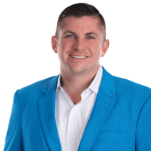 Rennie Barton, REALTOR® / Owner of City2Shore Arete Collection, in a blue suit