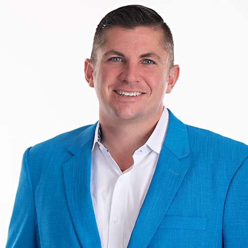 Rennie Barton, REALTOR® / Owner of City2Shore Arete Collection, in a blue suit